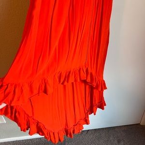 orange red bright and fun. Midi length with slight high low.